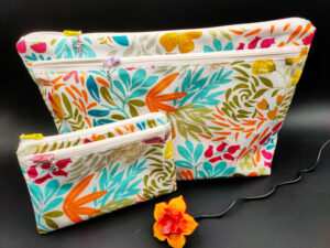 Trousse de toilette et pochette blanches feuilles fleurs colorées Les sacs de Cath Trousse de toilette et pochette blanches feuilles fleurs colorées, en tissu enduit imperméable. Les sacs de Cath