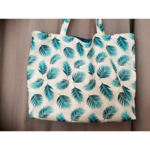 Sac de plage blanc feuilles bleues enduit avec une poche intérieure zippée, un mousqueton accroche-clé